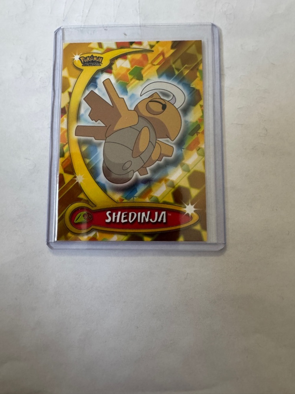 Topps Shedinja Card with Red and Gold Holo Accents